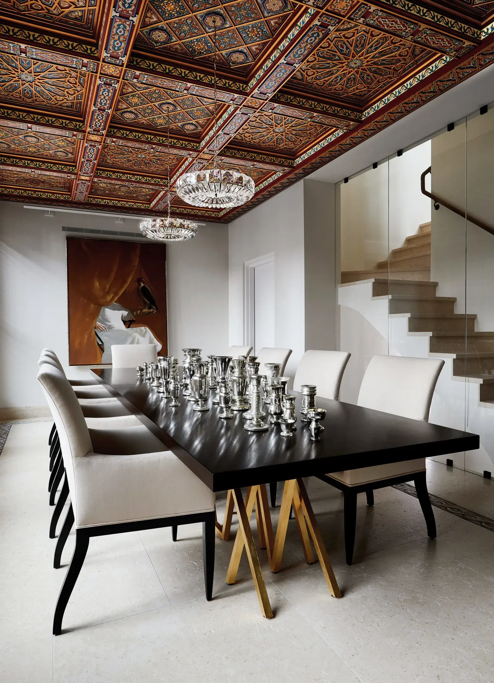 Dining room beneath a hand-painted coffered wooden ceiling